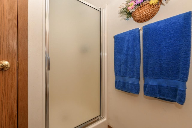 full bath with a shower stall