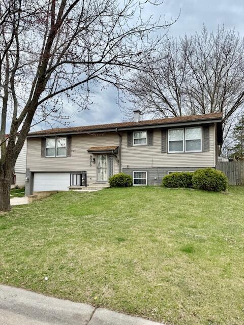 9073 N Joyce Ave, Milwaukee, WI 53224 - view of front of property featuring fence, a chimney, a front yard, and an attached garage