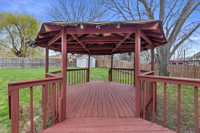 9073 N Joyce Ave, Milwaukee, WI 53224 - wooden deck featuring an outdoor structure, a storage shed, a yard, and a fenced backyard