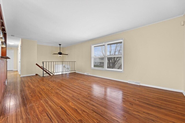 9073 N Joyce Ave, Milwaukee, WI 53224 - unfurnished room featuring ornamental molding, dark wood-style flooring, baseboards, visible vents, and a ceiling fan
