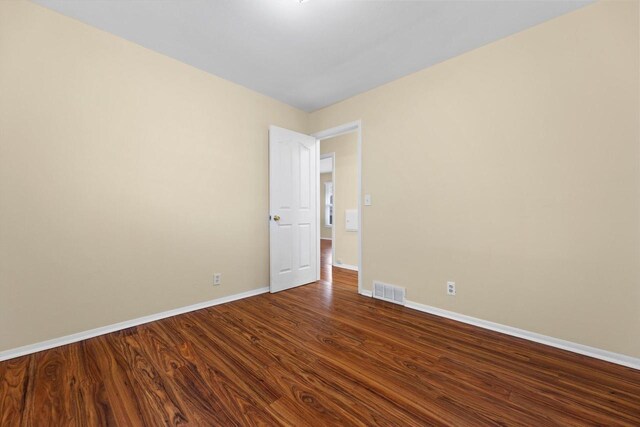 9073 N Joyce Ave, Milwaukee, WI 53224 - spare room with visible vents, wood finished floors, and baseboards