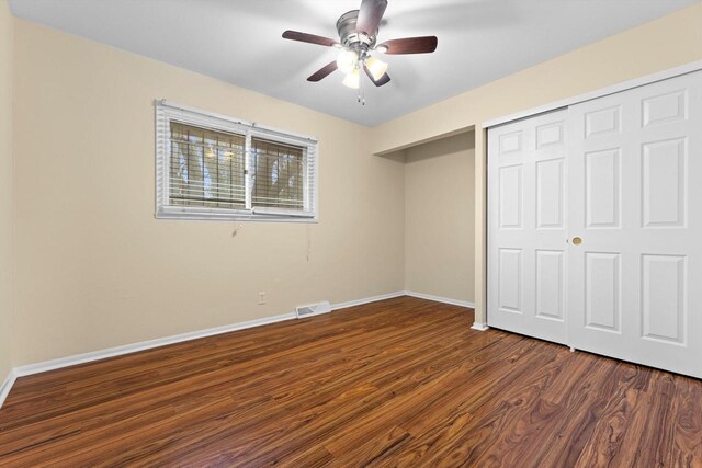 9073 N Joyce Ave, Milwaukee, WI 53224 - unfurnished bedroom with a closet, dark wood-type flooring, a ceiling fan, visible vents, and baseboards