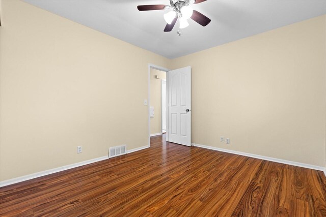 9073 N Joyce Ave, Milwaukee, WI 53224 - spare room with visible vents, a ceiling fan, dark wood-style floors, and baseboards