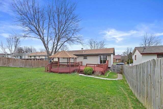9073 N Joyce Ave, Milwaukee, WI 53224 - rear view of property with a gazebo, a wooden deck, a fenced backyard, and a yard