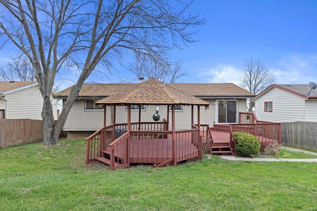9073 N Joyce Ave, Milwaukee, WI 53224 - rear view of house with a wooden deck, a gazebo, roof with shingles, a lawn, and a fenced backyard