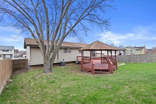 9073 N Joyce Ave, Milwaukee, WI 53224 - rear view of property with a gazebo, a fenced backyard, central AC unit, and a lawn