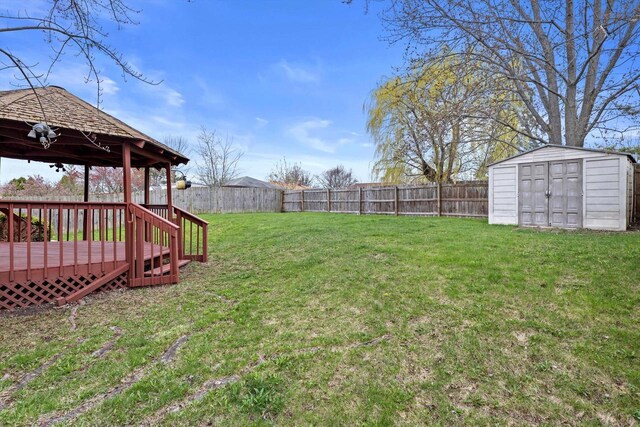 9073 N Joyce Ave, Milwaukee, WI 53224 - view of yard featuring a wooden deck, an outdoor structure, a storage shed, and a fenced backyard
