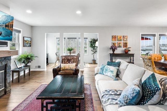 living area with recessed lighting, visible vents, plenty of natural light, and a fireplace