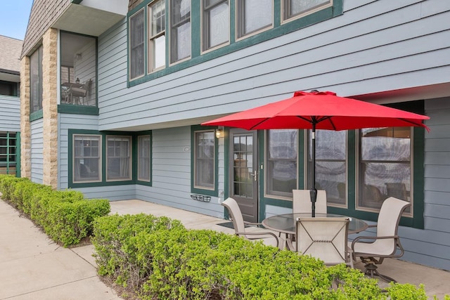 view of exterior entry featuring a patio area