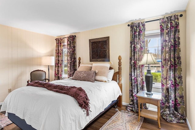 bedroom with baseboards and wood finished floors