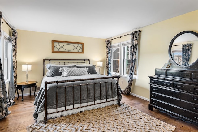 bedroom featuring baseboards and wood finished floors