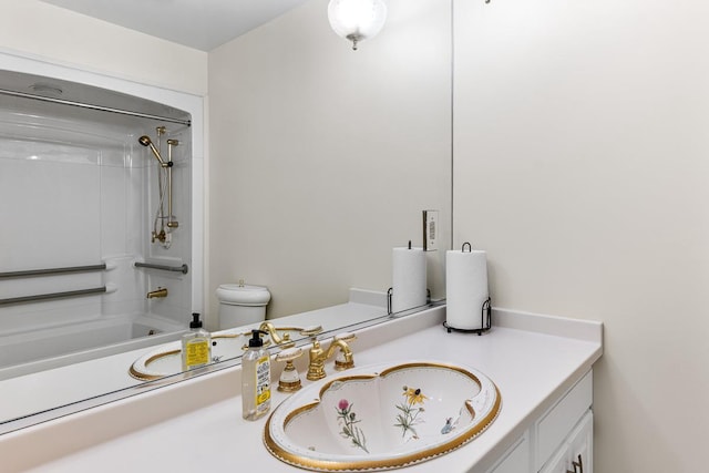 bathroom featuring toilet, vanity, and tub / shower combination