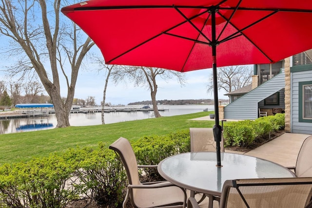 view of patio / terrace featuring outdoor dining space and a water view