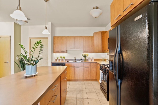 kitchen featuring hanging light fixtures, a sink, light countertops, light tile patterned floors, and black appliances