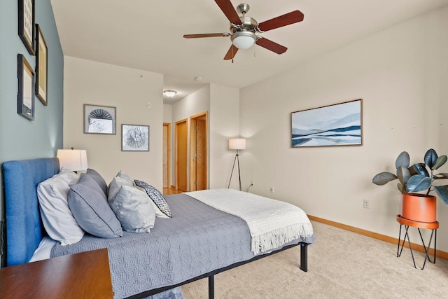 carpeted bedroom with baseboards and ceiling fan