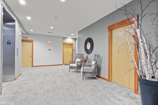 hall featuring visible vents, baseboards, elevator, recessed lighting, and carpet flooring
