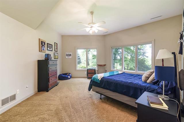 bedroom with visible vents, baseboards, a ceiling fan, and light carpet