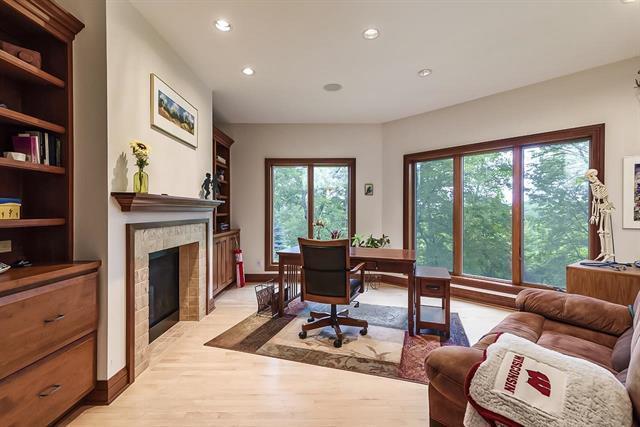 home office featuring a fireplace, light wood finished floors, baseboards, and recessed lighting