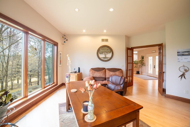 living area with baseboards, light wood-style flooring, recessed lighting, and plenty of natural light