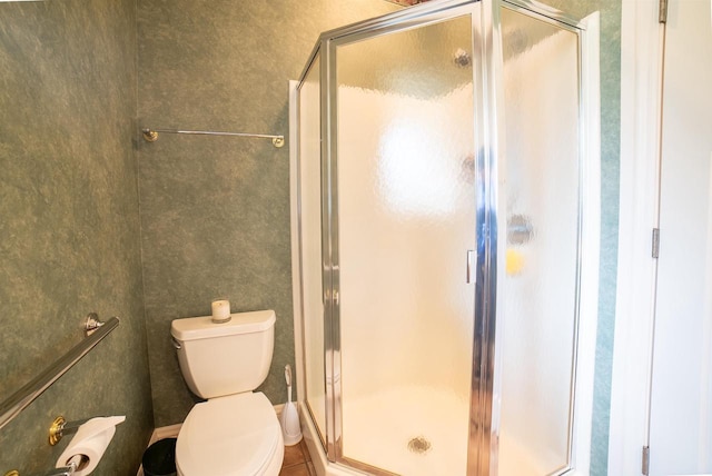 bathroom with toilet and a shower stall