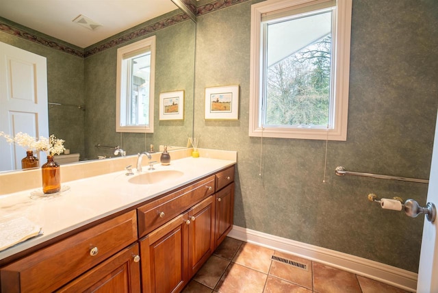 bathroom featuring vanity, a wealth of natural light, visible vents, and tile patterned flooring