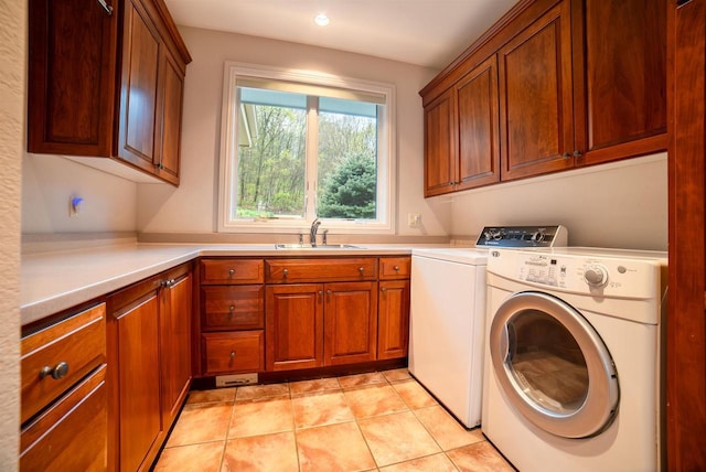 laundry area featuring a sink, cabinet space, washing machine and dryer, and recessed lighting