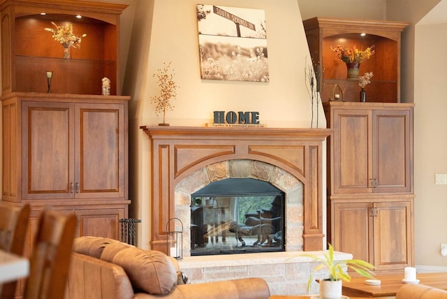 living area featuring a stone fireplace