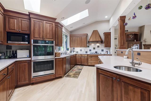 kitchen featuring backsplash, light countertops, appliances with stainless steel finishes, and a sink