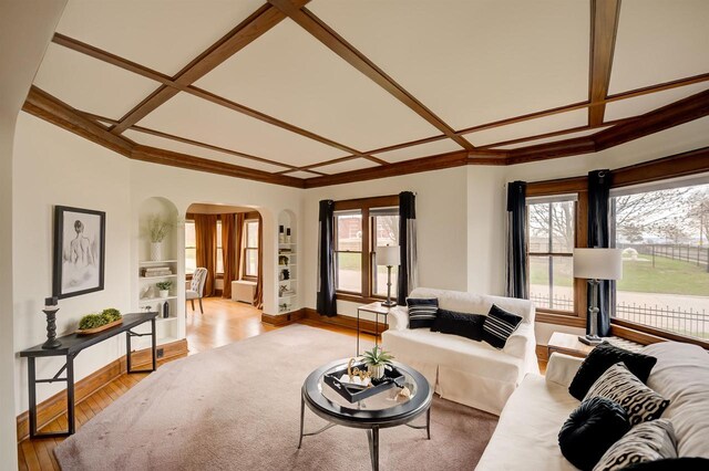 1324 Washington Ave, Oshkosh, WI 54901 - living area featuring crown molding, arched walkways, coffered ceiling, and a wealth of natural light