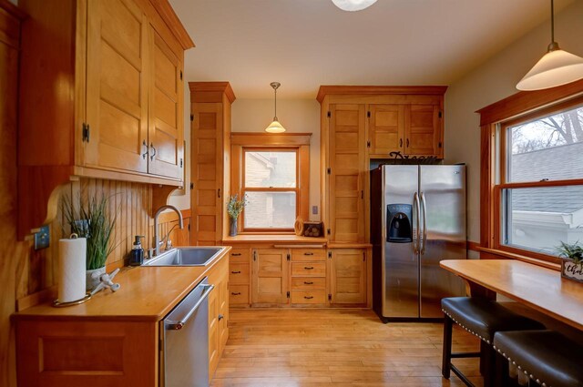 1324 Washington Ave, Oshkosh, WI 54901 - kitchen with a sink, pendant lighting, stainless steel appliances, and light wood finished floors
