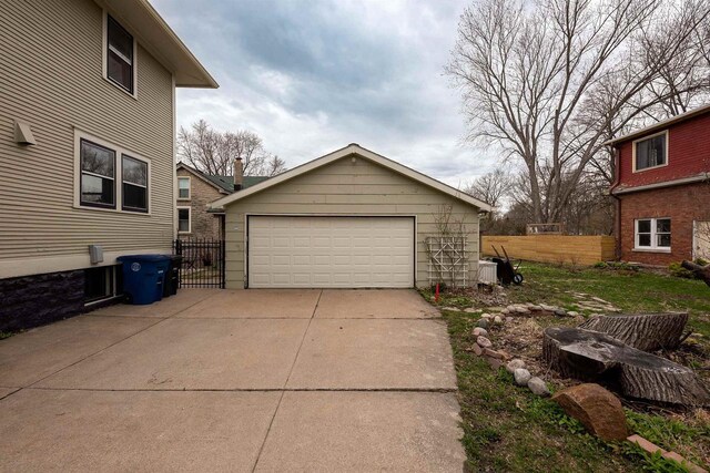 1324 Washington Ave, Oshkosh, WI 54901 - view of property exterior with a detached garage, fence, and an outbuilding