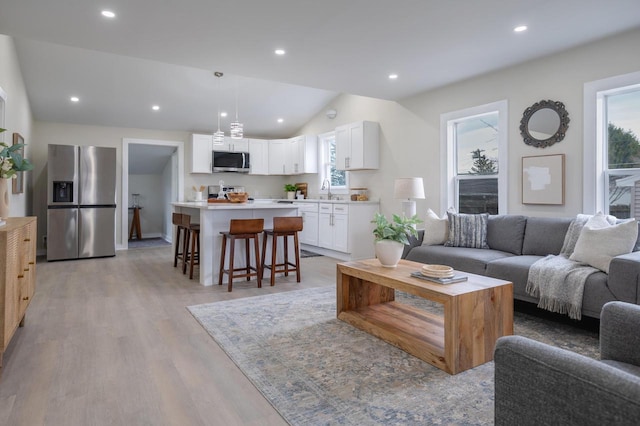 3326 6 Mile Rd, Racine, WI 53402 - living room with recessed lighting, vaulted ceiling, and light wood-style floors