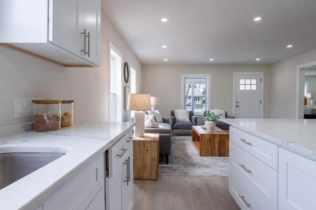 3326 6 Mile Rd, Racine, WI 53402 - kitchen with recessed lighting, light stone countertops, white cabinets, and light wood-style floors