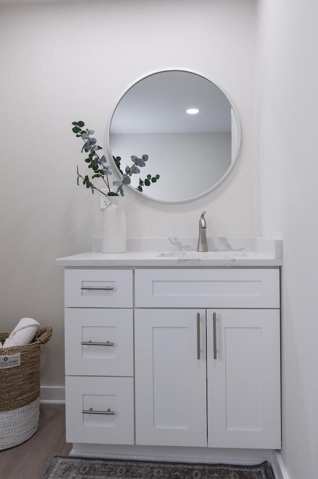 3326 6 Mile Rd, Racine, WI 53402 - bathroom with wood finished floors, vanity, and baseboards