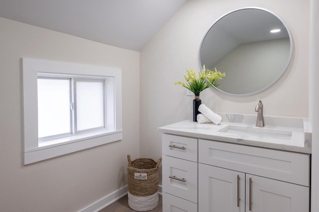 3326 6 Mile Rd, Racine, WI 53402 - bathroom with wood finished floors, vanity, and baseboards
