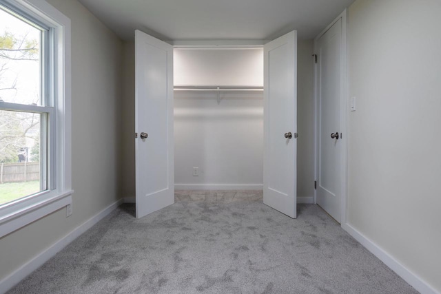 3326 6 Mile Rd, Racine, WI 53402 - unfurnished bedroom featuring baseboards, carpet floors, multiple windows, and a closet