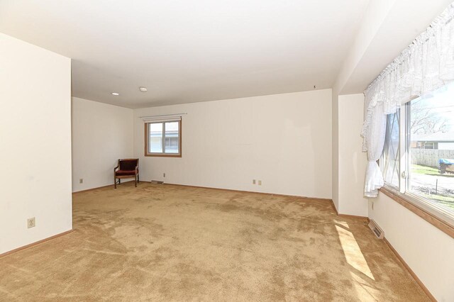 carpeted spare room featuring visible vents