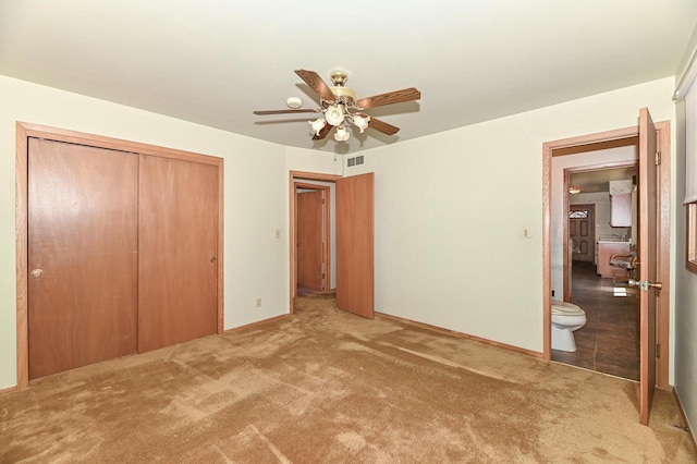 unfurnished bedroom with carpet flooring, visible vents, a closet, and baseboards