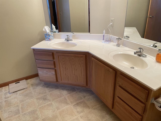 full bathroom with double vanity and a sink