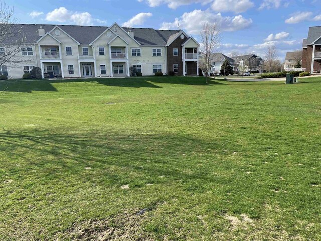 view of community with a residential view and a lawn