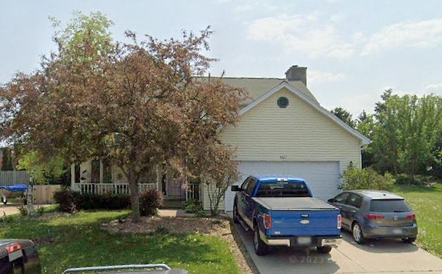 4327 29th St, Kenosha, WI 53144 - view of front of property with driveway, a garage, and a chimney