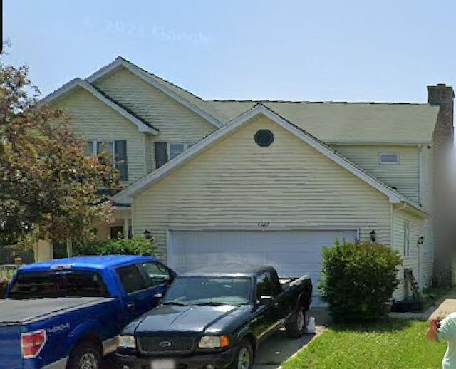 4327 29th St, Kenosha, WI 53144 - view of home's exterior with an attached garage and a chimney