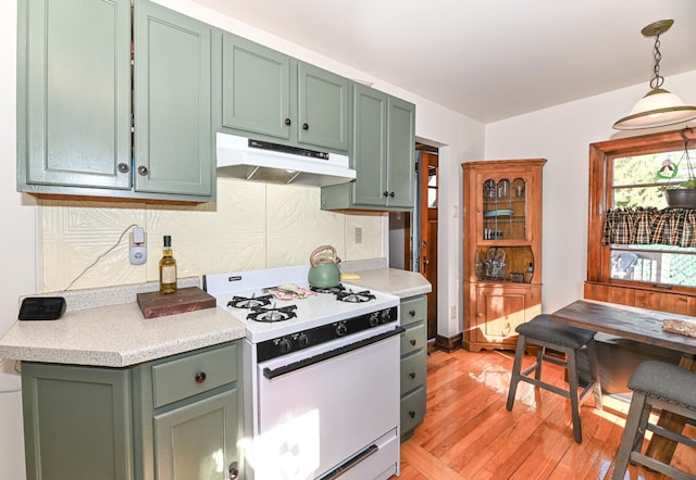 4308 W Dr, Delavan, WI 53115 - kitchen with green cabinetry, light wood finished floors, white gas range oven, and under cabinet range hood