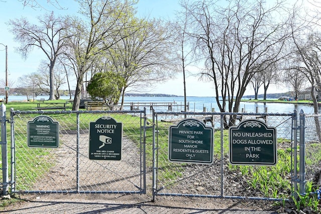 4308 W Dr, Delavan, WI 53115 - view of gate with fence, a yard, and a water view