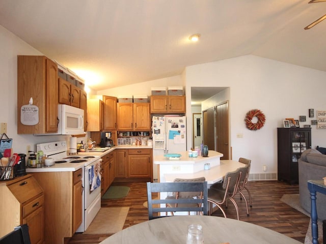 kitchen featuring visible vents, light countertops, vaulted ceiling, dark wood-type flooring, and white appliances