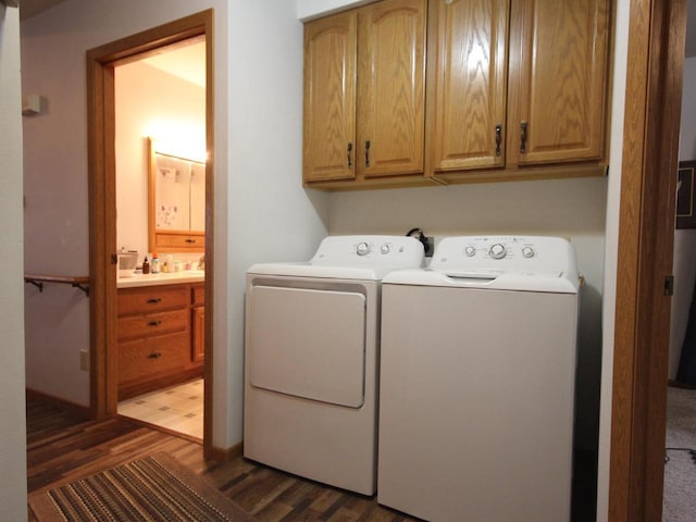 clothes washing area with separate washer and dryer, cabinet space, and wood finished floors