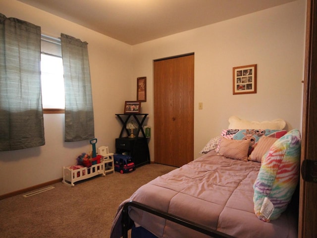 carpeted bedroom with visible vents and baseboards