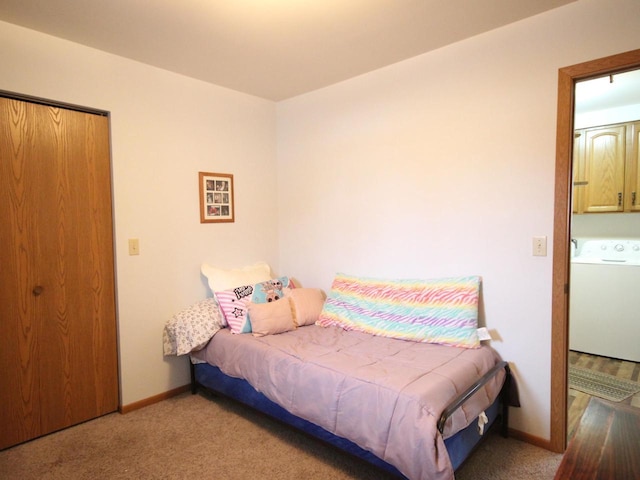 bedroom featuring baseboards, washer / clothes dryer, and carpet floors