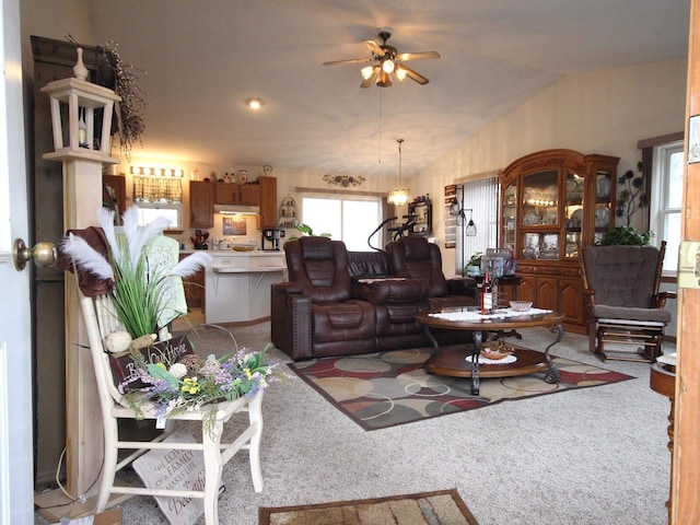 carpeted living room featuring ceiling fan and lofted ceiling