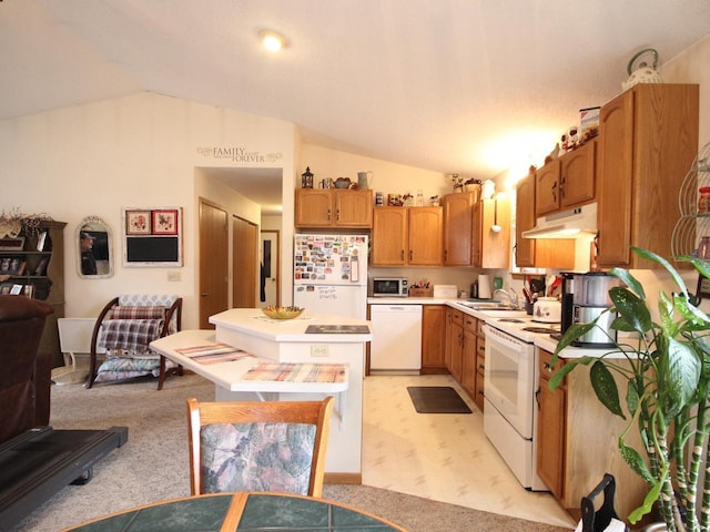 kitchen featuring a sink, under cabinet range hood, a kitchen island, vaulted ceiling, and white appliances